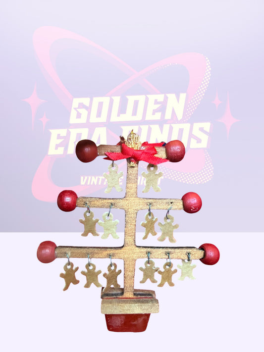 Wooden Christmas tree adorned with gold-painted gingerbread man